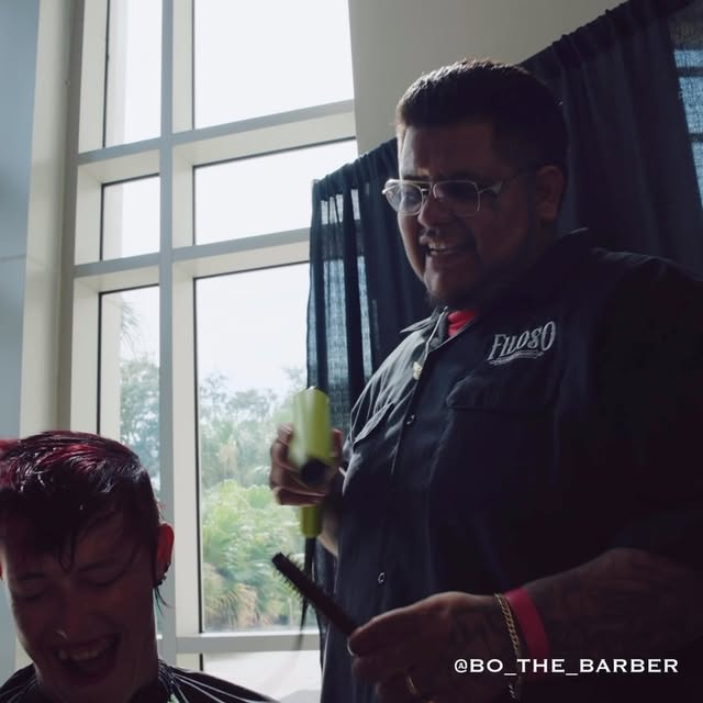 Bo working behind the chair during a haircut